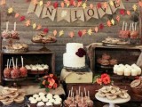 a rustic fall bridal shower dessert bar with leaves, a burlap banner and lots of fall-themed treats and sweets