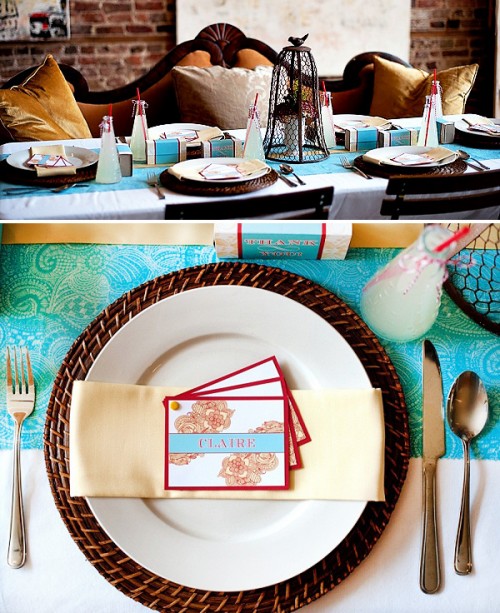 a bold place setting done in turquoise, burgundy and orange plus woven chargers