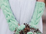 mint-colored mittens and a wedding bouquet of pinecones and mint knit pieces are amazing for a winter wedding, they will add a bit of color