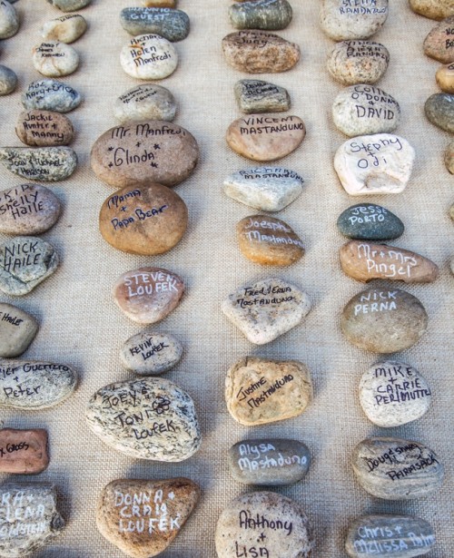 white burlap with various pebbles and rocks and names on them is a quick and natural DIY to try