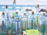 blue bottles with names written on tags is a nice idea to display wedding escort cards for a beach wedding
