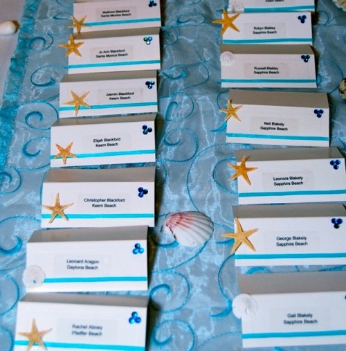striped wedding escort cards and starfish are ideal for a simple beach wedding