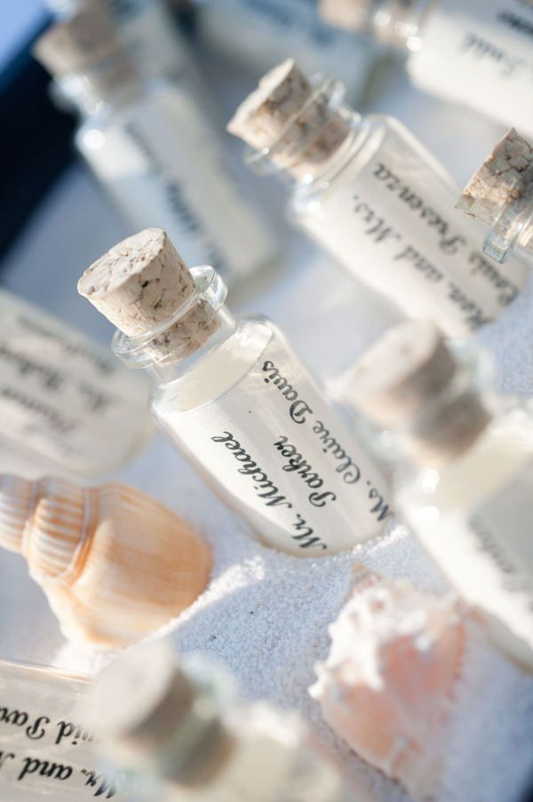a box with seashells and mini bottles with letters with names is a chic traditional decoration for a beach wedding