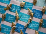 bright escort cards in all shades of blue and with sea creature figurines attached is a very bold and fresh idea