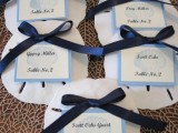 white oversized seashells made of clay, with navy bows and blue and white cards are very stylish and timeless for a nautical wedding