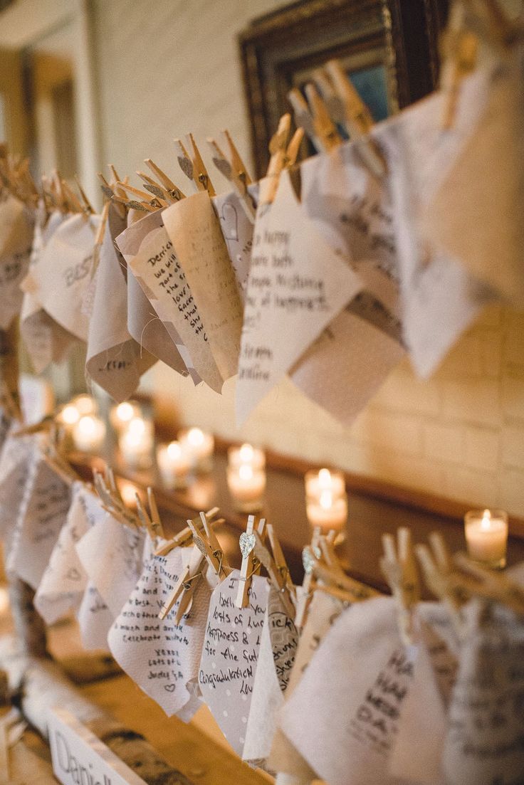 pieces of paper and cardboard attached to the ropes with clothespins and some candles around