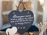 a chalkboard head stand with little paper hearts, on which the guests can leave messages