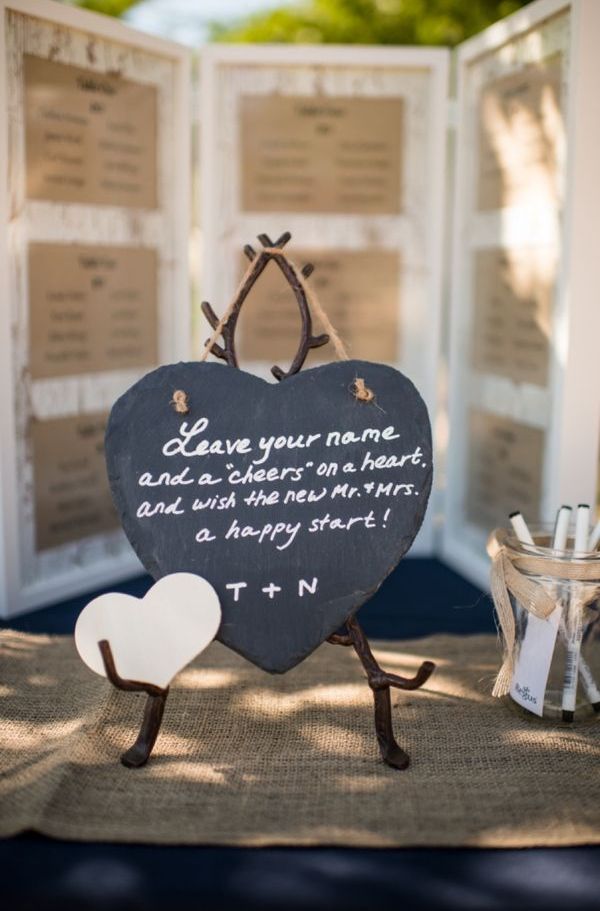 A chalkboard head stand with little paper hearts, on which the guests can leave messages