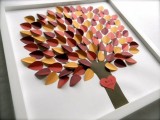 a simple framed wedding guest book with colorful paper leaves is a stylish idea