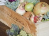 a rustic crate with lots of real fresh vegetables is a perfect centerpiece for a rustic wedding