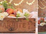 an industrial crate with peaches is a cool idea of a centerpiece for a southern wedding