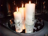 a mirror tray with embellished candles and pearls for a modern wedding