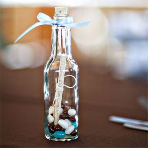 a bottle with candies and tags is a cool idea of a wedding favor, will fit most of wedding themes and styles