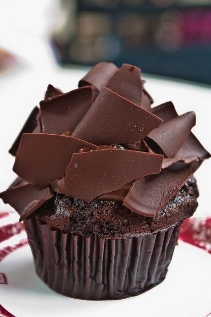 a delicious chocolate cupcake topped with chocolate shards is a lovely wedding dessert idea, an alternative to a wedding cake or an addition to it