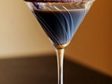 a chocolate cocktail with a chocolate edge and some confetti is a delicious signature drink type