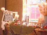 a chic fall wedding cider bar created of a cart, wheat, apples and pallets and drinks