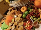a rustic fall grazing table with grapes, apples, pumpkins, bakery and olive plus sauces
