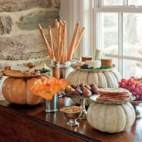a fall wedding food station with crackers, various kinds of cheese and fruits - grapes, figs, apples