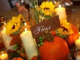 a cardboard calligraphy card is a nice fit for a bright flower, pumpkins and leaf centerpiece and candles