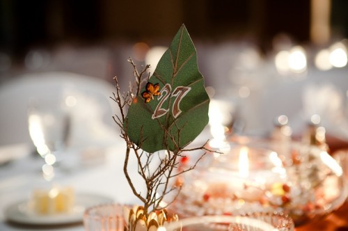 branches with berries, a paper leaf with rhinestones and a table number is a nice fit for a fall wedding
