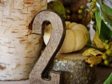 a plywood table number is a nice idea for a fall wedding centerpiece, you can pair it with pumpkins, greenery, stumps and other stuff