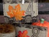 burlap table numbers with black lace and bright faux leaves are cool DIYs for your fall wedding