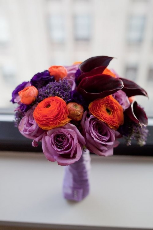 a moody Halloween wedding bouquet of purple, deep purple and orange blooms is a very bold statement