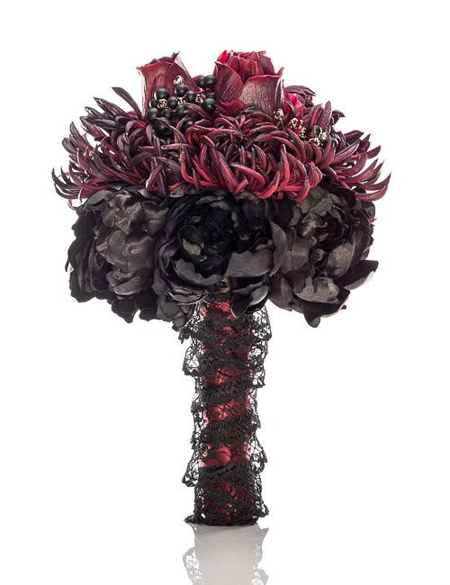 a predator looking Halloween wedding bouquet of black and burgundy blooms, privet berries, with a red and black wrap