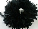 a glam black feather bouquet with an embellishment in the center is a refined and chic idea of a Halloween wedding bouquet