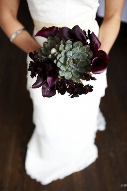 a depe purple Halloween wedding bouquet of callas with a large green succulent is a creative and trendy piece