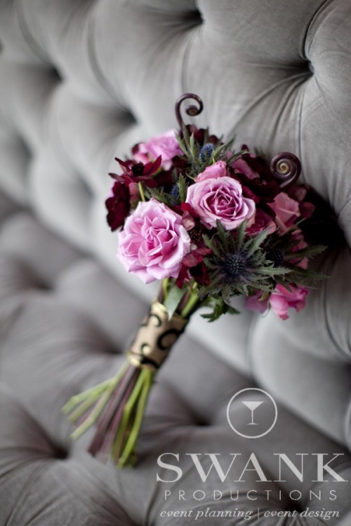 a moody Halloween bouquet of pink and dark blooms, thistles and twigs is a stylish idea for a Halloween bride