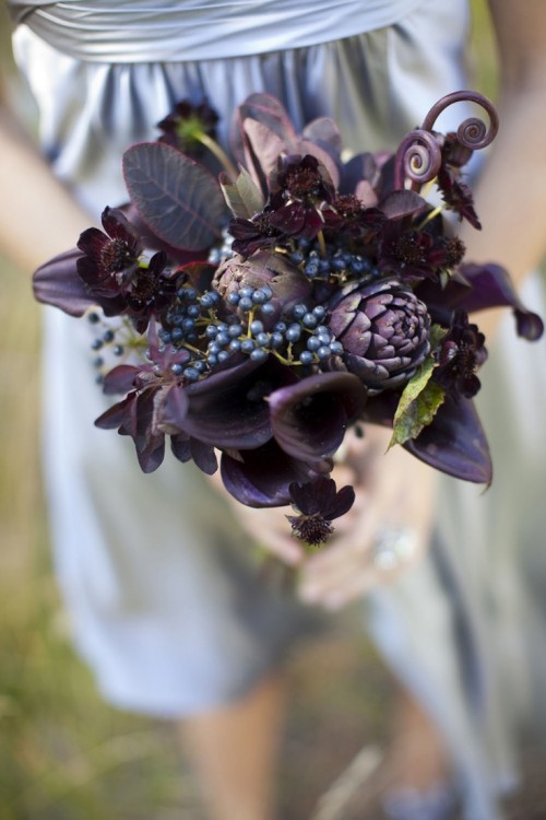 a dark Halloween bouquet of callas, artichokes, privet berries, dark foliage and lotus is very elegant