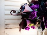 a dark Halloween bouquet of deep purple callas, purple blooms and twigs plus greenery is a stylish idea