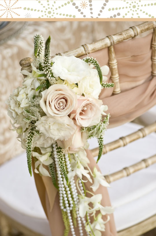 Mauve ribbons, mauve and white roses, pearls and greenery for chair decor
