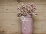 a mauve colored mason jar with pink and mauve blooms can be a wedding centerpiece or just a decoration