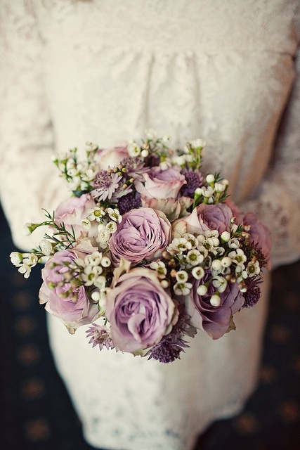 a chic and delicate wedding bouquet of mauve roses and mini white blooms is very cute