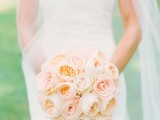 a pretty peachy and blush wedding bouquet of roses and peony roses is a stylish idea for a bride