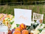 fresh peaches in a silver bowl can be an edible centerpiece or an addition to a lush floral table runner like here
