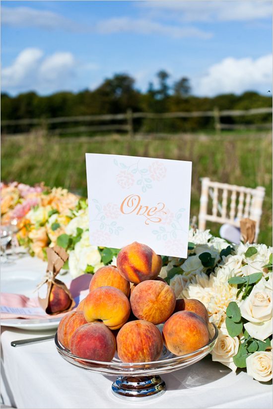 fresh peaches in a silver bowl can be an edible centerpiece or an addition to a lush floral table runner like here
