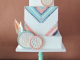 a bright boho wedding cake with colorful geometric patterns and sugar dream catchers in matching colors