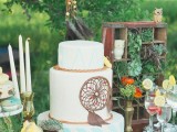a white and striped wedding cake in mint, white and with a chocolate dream catcher for decor