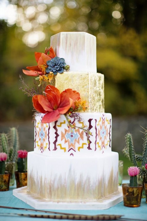 a bright wedding cake with white and gold tiers, a boho ethnical tier, dried herbs and sugar flowers in bold shades