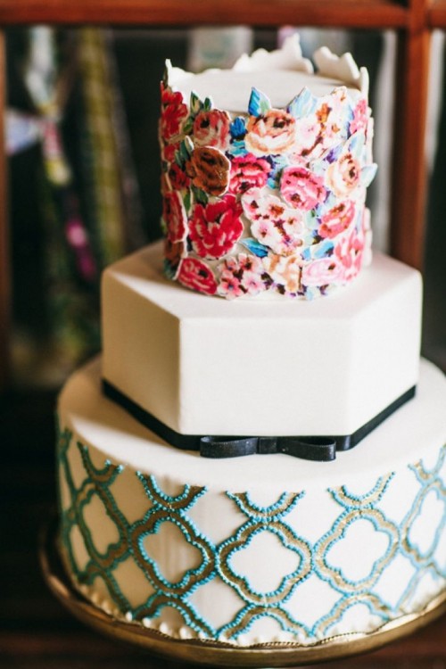 a bright wedding cake with a white geometric tier, a printed and a floral one for a whimsical wedding