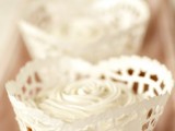 cupcakes with white rose icing on them are a timeless wedding dessert idea for any season
