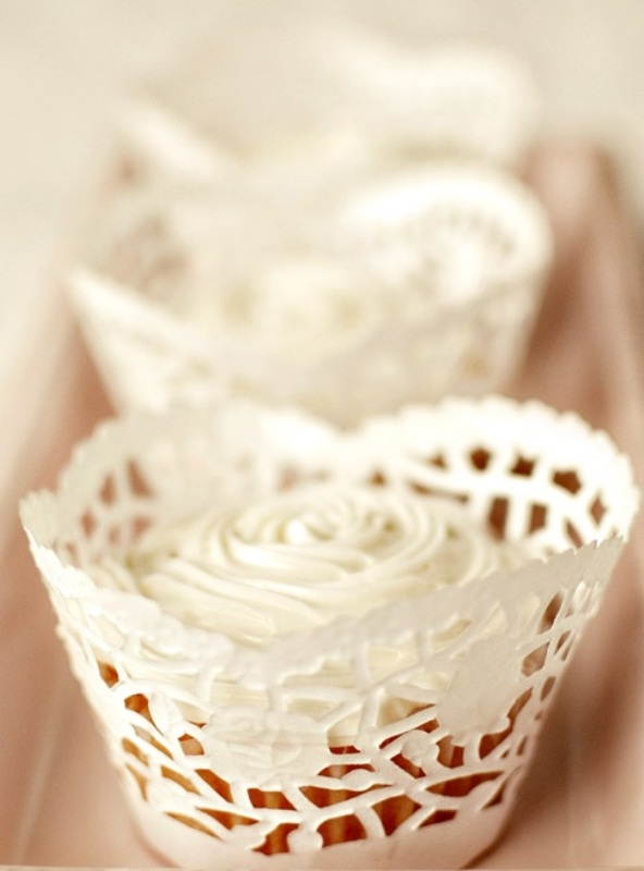 cupcakes with white rose icing on them are a timeless wedding dessert idea for any season