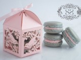 a pink laser cut box with grey and pink macarons are a gerat idea of a wedding favor, they can be given at any wedding
