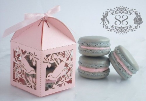 a pink laser cut box with grey and pink macarons are a gerat idea of a wedding favor, they can be given at any wedding