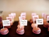 tiny pink macarons topped with names are a creative wedding seating chart for any wedding, they will tell your guests where to go in a tasty way