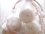 a refined lace sack with monogrammed white macarons is a lovely idea for a wedding, they can make very chic favors