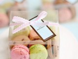 a clear box with colorful macarons as a lovely wedding favor for a modern wedding with plenty of color